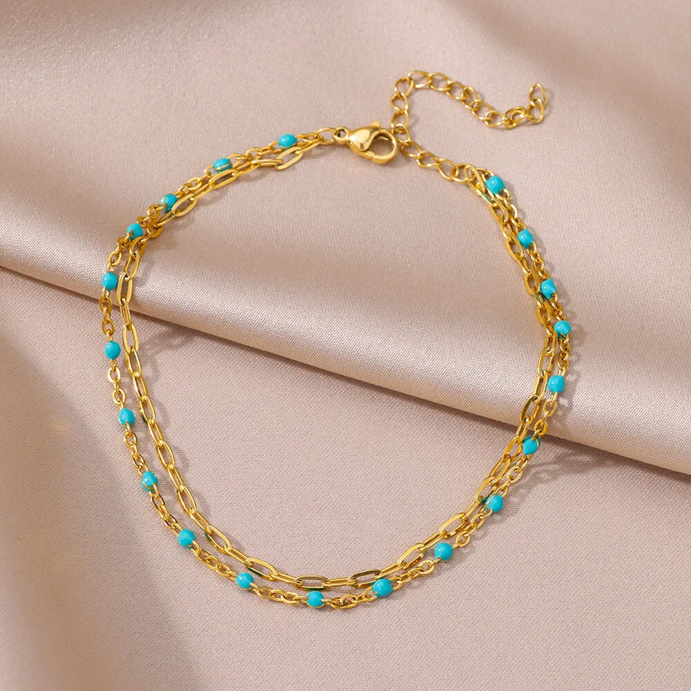 Chaîne de Cheville Dorée avec Croix et Pierres Zirconium